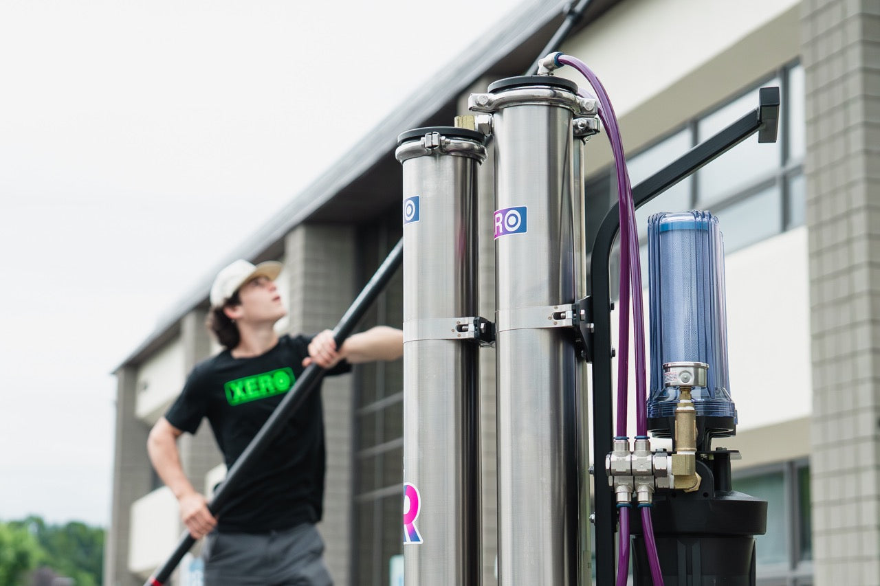 XERO Triple Pure in use with a window cleaner in the background