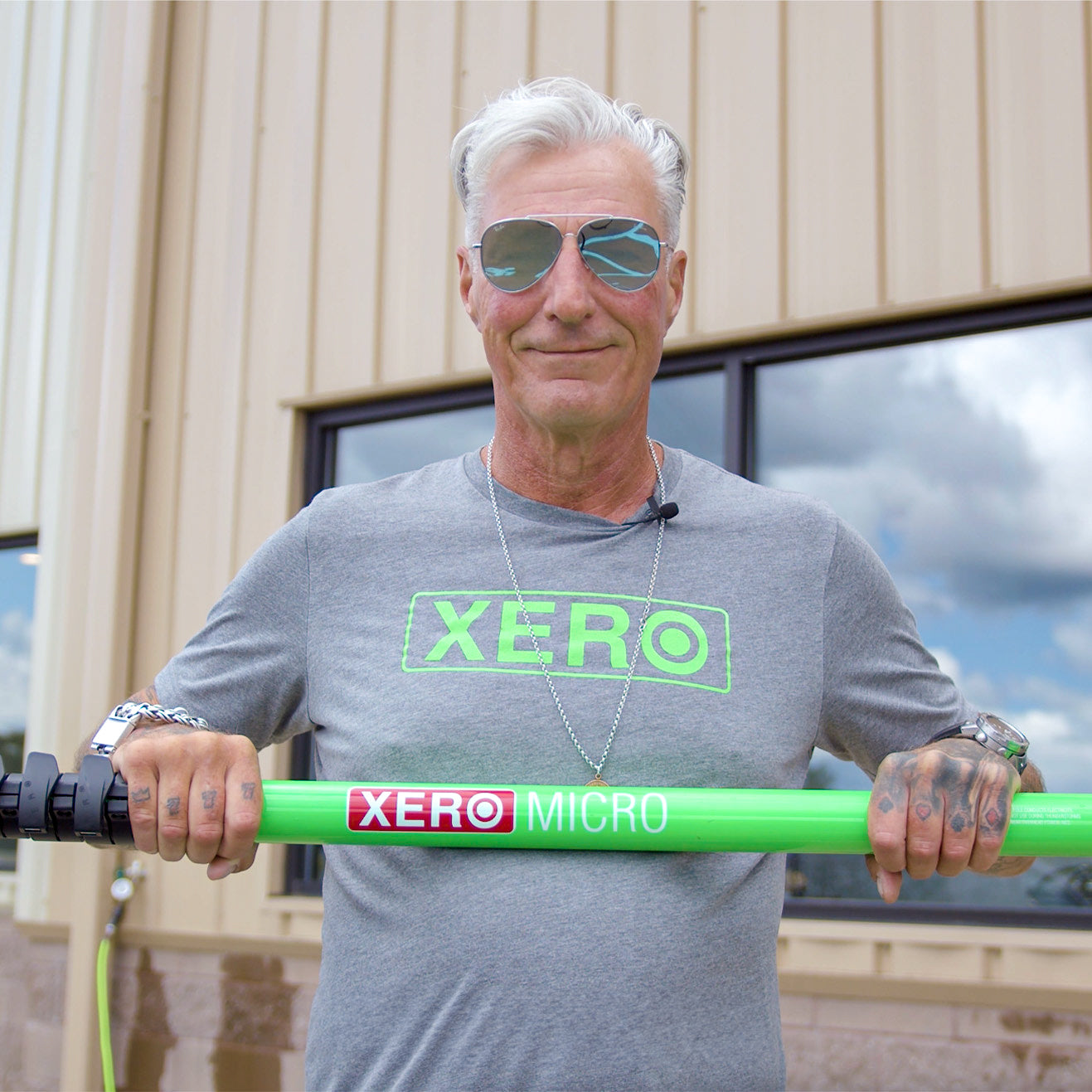 Frank Rave holding Neon Green XERO Micro Basic Water Fed Pole