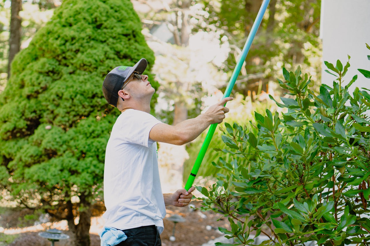 The XERO Carbon Fiber Trad Pole 2.0 Being Used by a Window Cleaner