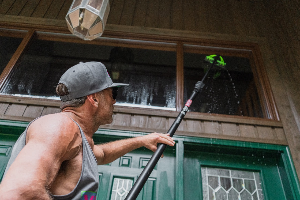 Window cleaner using a XERO Pro Basic 30 Foot Pole to clean windows on a residential job,